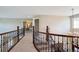 Second floor hallway showing the railing overlooking the living room below at 3970 White Bay Dr, Highlands Ranch, CO 80126