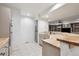 Kitchen featuring stainless appliances, breakfast bar with butcher block countertops and view of den at 3970 White Bay Dr, Highlands Ranch, CO 80126