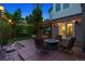 Paver patio with outdoor kitchen and barbecue, seating area and hanging string lights at 3970 White Bay Dr, Highlands Ranch, CO 80126