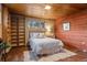 Cozy bedroom features stone floors, a built-in bookcase, and comfortable decor at 8258 W 66Th Dr, Arvada, CO 80004