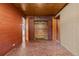 Hallway area with stone floors, wood paneling, and multiple closets at 8258 W 66Th Dr, Arvada, CO 80004