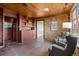 A secondary sunroom with brick walls, wooden ceilings, and built-in shelving at 8258 W 66Th Dr, Arvada, CO 80004