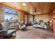 Spacious sunroom living room with brick walls, wooden ceilings, and terracotta floors at 8258 W 66Th Dr, Arvada, CO 80004