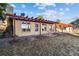 Back exterior of home with brick, windows, and outdoor swing at 8258 W 66Th Dr, Arvada, CO 80004