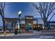 A street view of the Tocoalli restaurant with outdoor seating and a modern facade at 8258 W 66Th Dr, Arvada, CO 80004