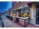 A street view of the Wine Cellar Bistro with outdoor tables and brick facade at 8258 W 66Th Dr, Arvada, CO 80004