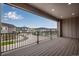 Spacious balcony with sleek black railings and a relaxing space for enjoying the outdoors and neighborhood views at 16774 W 93Rd Pl, Arvada, CO 80007