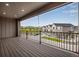 Spacious balcony with sleek black railings and views of the community and beautiful mountain scenery in the distance at 16774 W 93Rd Pl, Arvada, CO 80007