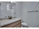 Stylish bathroom featuring granite countertops and modern hardware with warm lighting at 16774 W 93Rd Pl, Arvada, CO 80007