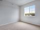 Bright, carpeted room with neutral paint, window with blinds, and central air at 16774 W 93Rd Pl, Arvada, CO 80007