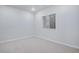 Bright bedroom with neutral carpet, walls, and large window, perfect for relaxation at 16774 W 93Rd Pl, Arvada, CO 80007