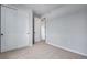 Neutral bedroom with closet and entry to other rooms; light walls and carpet at 16774 W 93Rd Pl, Arvada, CO 80007