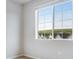 Bedroom view of the exterior neighborhood landscape view through a large window at 16774 W 93Rd Pl, Arvada, CO 80007