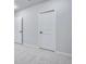 Bedroom has neutral carpet and paint, with white doors and a baseboard trim at 16774 W 93Rd Pl, Arvada, CO 80007