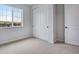 Bright bedroom with large window, plush carpet and closet for ample storage at 16774 W 93Rd Pl, Arvada, CO 80007