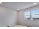 Light-filled bedroom with dual windows offering neighbourhood views and plush carpet at 16774 W 93Rd Pl, Arvada, CO 80007