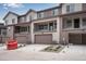 Exterior view of townhomes with attached garages and balconies at 16774 W 93Rd Pl, Arvada, CO 80007