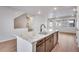 Modern kitchen island features a stylish faucet, and dark wood cabinets at 16774 W 93Rd Pl, Arvada, CO 80007