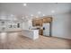 Bright, modern kitchen features a center island, stainless steel appliances, and wood floors at 16774 W 93Rd Pl, Arvada, CO 80007