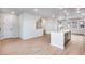Modern kitchen features a center island and open concept layout with light wood floors at 16774 W 93Rd Pl, Arvada, CO 80007
