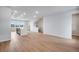 Open-concept living room with wood floors leads into the kitchen and features stairs to the upper level at 16774 W 93Rd Pl, Arvada, CO 80007