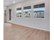 Bright living room with wood floors and lots of natural light from the many windows to the neighborhood view at 16774 W 93Rd Pl, Arvada, CO 80007