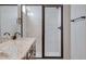 Glass enclosed shower with tile surround offering a clean and elegant design at 16774 W 93Rd Pl, Arvada, CO 80007