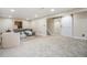 Spacious carpeted basement area with a comfortable gray couch and stylish decor at 8543 W Arizona Dr, Lakewood, CO 80232