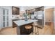 This kitchen features dark wood cabinets, stainless steel appliances and a large island with a white countertop at 8543 W Arizona Dr, Lakewood, CO 80232