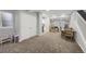 Expansive basement area with recreational space, kitchenette, and neutral colored carpeting throughout at 17052 Lipan St, Broomfield, CO 80023