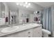Well-lit bathroom with double sinks, granite countertops, and blue accents at 17052 Lipan St, Broomfield, CO 80023