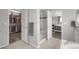 Bathroom showcasing a walk-in closet, glass shower and access to bedroom at 17052 Lipan St, Broomfield, CO 80023