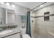 Bathroom featuring a granite-topped vanity, toilet and tiled shower with mosaic accents at 17052 Lipan St, Broomfield, CO 80023