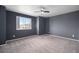 A spacious carpeted bedroom features a large window and modern ceiling fan at 17052 Lipan St, Broomfield, CO 80023
