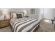 Cozy bedroom showcases a striped bedspread, bedside tables, and soft, neutral tones at 17052 Lipan St, Broomfield, CO 80023