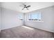 Bright carpeted bedroom with large window and ceiling fan at 17052 Lipan St, Broomfield, CO 80023