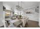 Stylish dining room with modern light fixture and view into the open living spaces at 17052 Lipan St, Broomfield, CO 80023