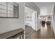 Elegant hallway featuring hardwood floors and an open view to a study and living area at 17052 Lipan St, Broomfield, CO 80023