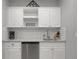 Modern kitchenette features sleek white cabinets, subway tile backsplash, and stainless steel appliances at 17052 Lipan St, Broomfield, CO 80023