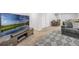 Finished basement media room with large TV and plush gray furniture, perfect for entertaining at 17052 Lipan St, Broomfield, CO 80023