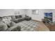 Comfortable living room featuring a plush gray sectional sofa and stylish patterned rug at 17052 Lipan St, Broomfield, CO 80023