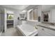 Serene primary bathroom with a soaking tub, double vanity, and plenty of natural light at 17052 Lipan St, Broomfield, CO 80023