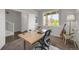 Bright home office featuring a modern desk, chair, and ample natural light at 17052 Lipan St, Broomfield, CO 80023