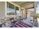 Inviting front porch with seating area, perfect for relaxing and enjoying the outdoors at 17052 Lipan St, Broomfield, CO 80023