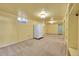 Finished basement area with built-in shelving and a refrigerator at 12152 E Dakota Ave, Aurora, CO 80012