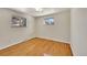 Well-lit bedroom featuring hardwood floors and multiple windows at 12152 E Dakota Ave, Aurora, CO 80012