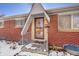 House entrance with brick facade and security door at 12152 E Dakota Ave, Aurora, CO 80012