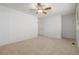 Neutral bedroom with tan carpet, ceiling fan, and a large window at 1922 Lydia Dr # 82, Lafayette, CO 80026