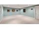 Spacious basement area with neutral carpeting, recessed lighting and soft blue wall color providing a versatile living space at 9925 W Progress Pl, Littleton, CO 80123