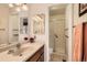 Bathroom featuring a neutral vanity with a sink and a glass-enclosed shower at 9925 W Progress Pl, Littleton, CO 80123